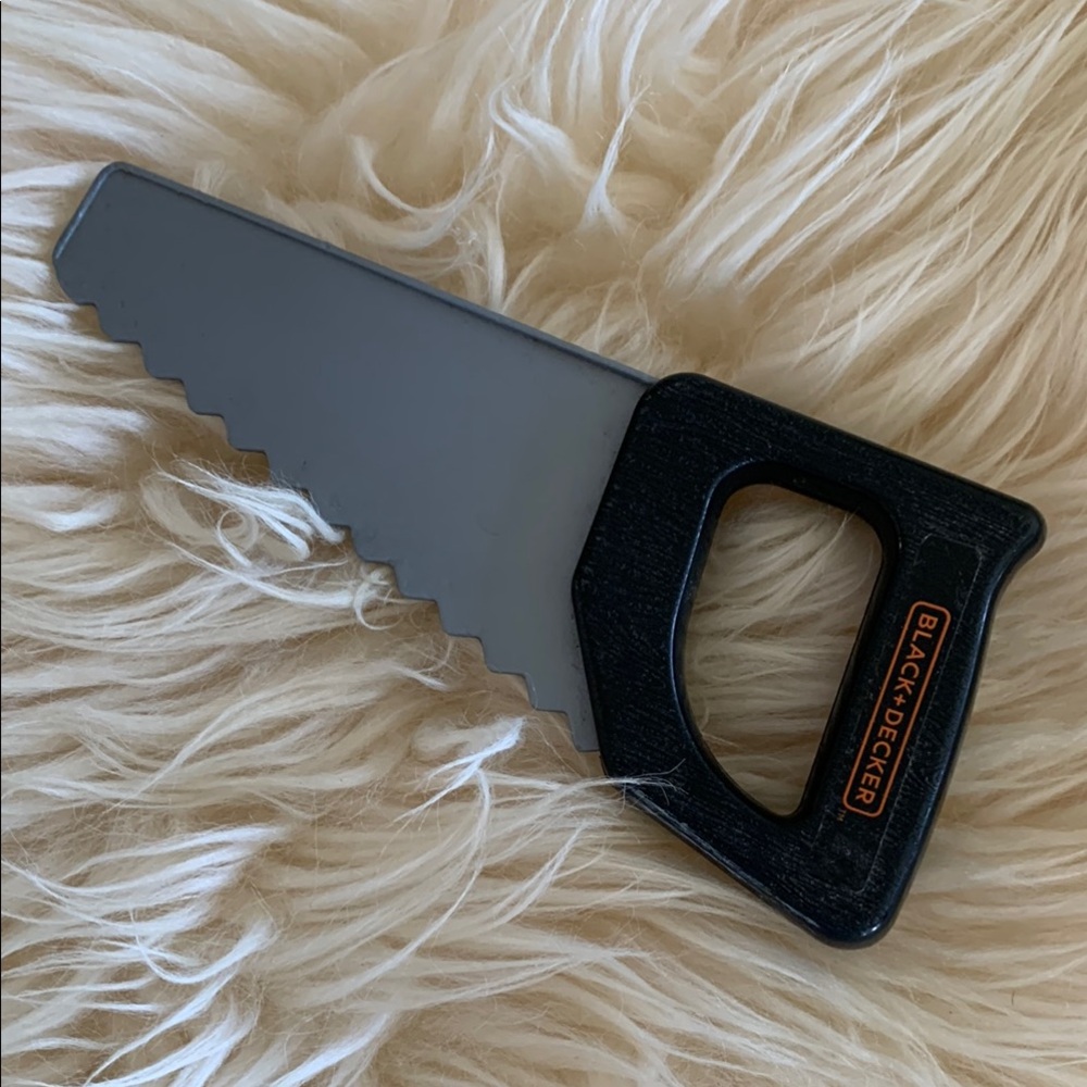 Free with purchase. Toy saw for tool bench